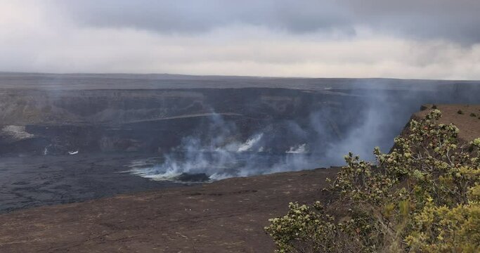 Hilo Hawaii Kilauea volcano steam smoke lava crater. Most active volcano in USA. Smoke, steam, gasses. Big Island in Volcano National Park. Eruptions lava flow. Geological ecosystem and environment.