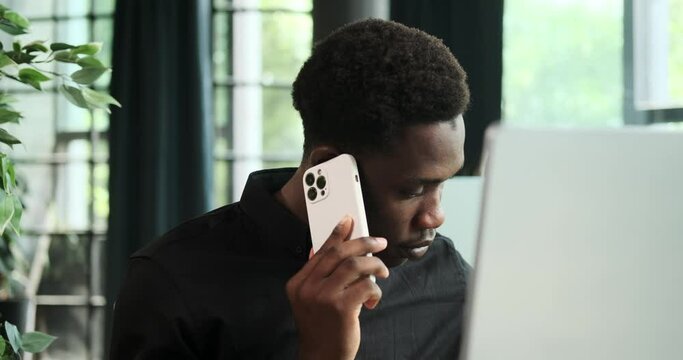 Black businessman is engaged in negotiations, showcasing assertiveness skills in business discussions. His ability to navigate conversations with confidence is evident in this scene of communication.