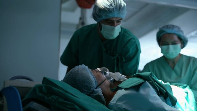 Doctor doing resuscitate a patient in oxygen mask resting on Bed in a hospital, CPR Cardiopulmonary resuscitation process