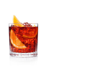 Negroni Cocktail in crystal glass with ice cubes and orange slices on white background with reflection.