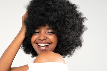 Closeup beauty portrait of natural, beautiful, young girl with afro hairstyle and big toothy smile.