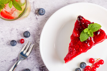 Cheesecake with fresh strawberries, red currants and blueberries