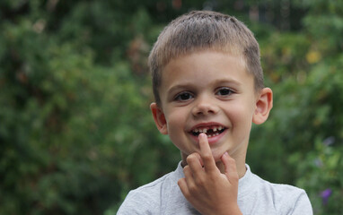 Fototapeta premium a boy without a tooth. Selective focus.