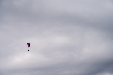 parachutist in the sky above the mountains in the valley, active recreation in the Ukrainian mountains
