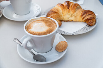 Breakfast with coffee and croissants