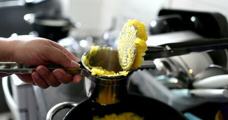 Close-up hands preparing mandioc food pressing ingredient