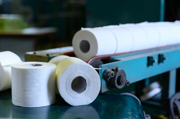 Toilet paper rolls moving along the conveyor belt. Old Greek factory for the production of paper...