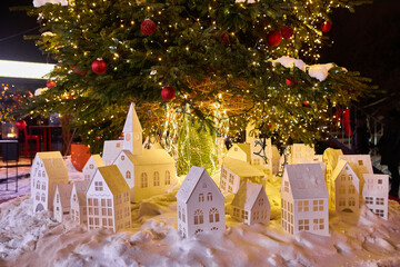 big beautiful Christmas Tree with decorations and Illuminations in snowy night. New Year and Christmas holiday background.
