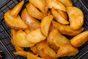 Delicious crispy fried potato wedges with salt, spices and herbs