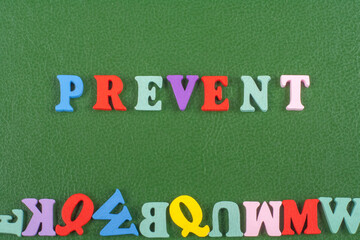 PREVENT word on green background composed from colorful abc alphabet block wooden letters, copy space for ad text. Learning english concept.