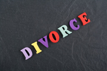 DIVORCE word on black board background composed from colorful abc alphabet block wooden letters, copy space for ad text. Learning english concept.