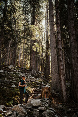 A guy in the forest, in Austrian Alps hiking to the Reedsee