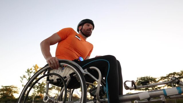 disabled paraplegic man in racing wheelchair resting after training, professional paralympic athlete