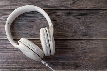 White headphones on a dark wooden background