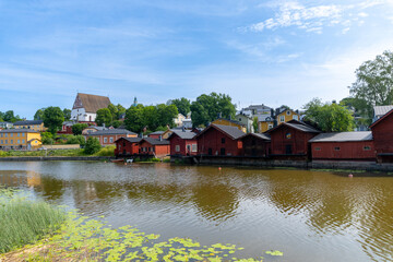 Obraz premium Panoramic view of the city of Porvoo in Finland. Little red houses next to the river. Day with clouds in the sky.