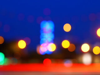 Blurry night city scene, colourful light cones, traffic light / abstract background webdesign