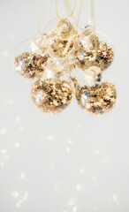 Transparent glass balls with gold stars sparkle in sunlight. Christmas decor.