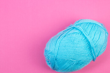 Knitting yarn for knitting on pink background.