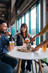 Group of Friends Having Pizza in a restaurant