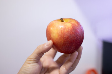 red apple in hand