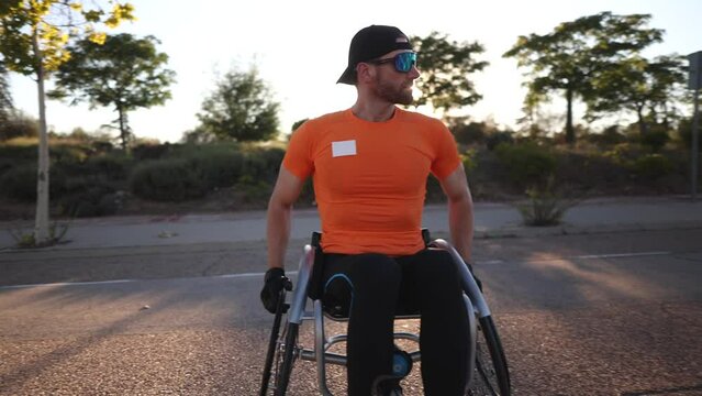 This Caucasian man in his forties is a wheelchair athlete who tirelessly trains with his racing wheelchair in preparation for the Paralympic Games
