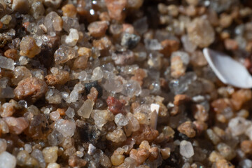 Macro photo of small quartz sand particles at a beach.