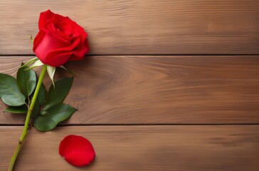 Naklejka na ściany i meble Beautiful red rose on wooden table with empty space. Romantic concept for Valentine's Day and Women's Day. Top view, flat lay.