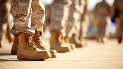 Fotobehang Close-up of men soldiers legs in uniform and boots on the sand ground. Line at military camp. Army defense, mobilization and conscription. Banner. Copy space © Garnar