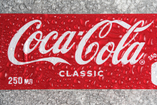 Kazakhstan Kostanay 10.06.2023 in studio. Coca Cola trademark is covered with cool drops.