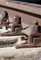 close-up of rusty iron bolts on the railway