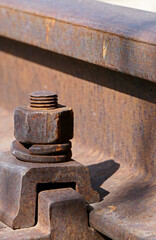 close-up of rusty iron bolts on the railway
