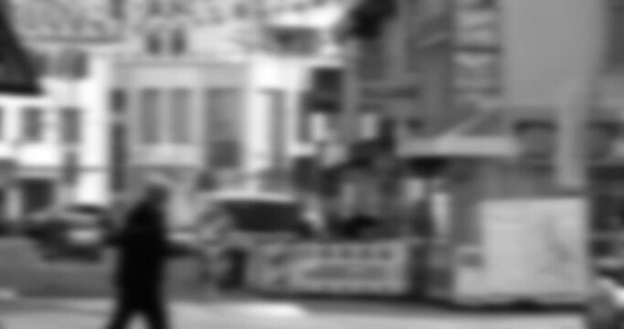 A black and white lens captures Achern's urban charm, as pedestrians meander, their silhouettes contrasting with enigmatic yet awe-inspiring buildings.