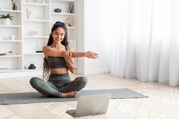 Fitness Enthusiast Young Indian Woman Engages in Home Laptop Workout