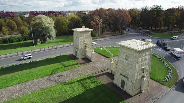 Aerial drone view of the historic Egyptian Gates in Pushkin, Tsarskoye Selo, Saint Petersburg, Russia. Neoclassical city gates surrounded by a landscaped park and urban roads.