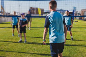 Volleyball game, junior teenage school team of kids play volleyball, players on the outdoor...