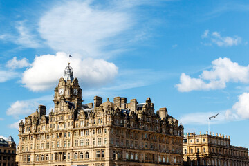 Fototapeta na wymiar Historical building with clock tower and Scottish flag on top, Edinburgh, Scotland, United Kingdom, Europe