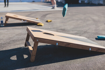 Cornhole game set, process of throwing bean bags, kids children tossing bean sacks, corn hole  in...