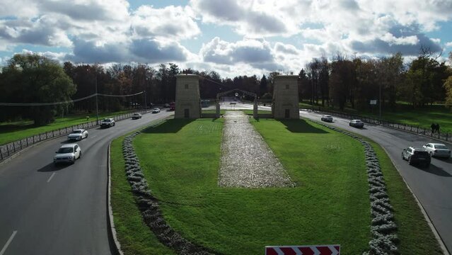 Aerial drone view of the historic Egyptian Gates in Pushkin, Tsarskoye Selo, Saint Petersburg, Russia. Neoclassical city gates surrounded by a landscaped park and urban roads.