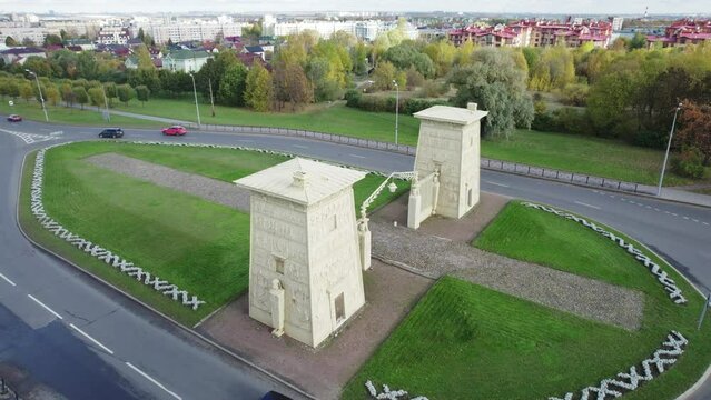 Aerial drone view of the historic Egyptian Gates in Pushkin, Tsarskoye Selo, Saint Petersburg, Russia. Neoclassical city gates surrounded by a landscaped park and urban roads.