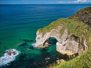The natural arch known as The Wishing Arch on the Antrim Coast, near Giant's Causeway, in Northern...