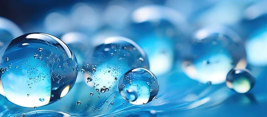 Schilderijen op glas Blue hydrogel balls with a reflective texture close up © Vusal