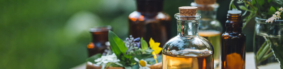 Herbal essential oil in old vintage apothecary glass bottles. Alternative medicine, skin care,...