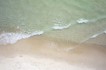 Clear emerald wave on a white sand beach Aerial view drone 