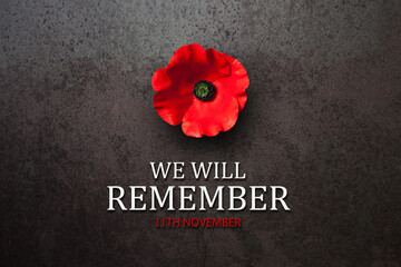 We Will Remember 11th November inscription with Poppy flower on rusty iron background. Decorative...