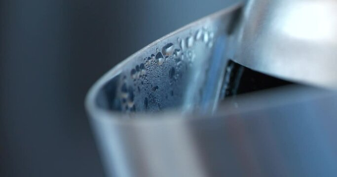 Formation of steam and condensation on the metal spout of the kettle when water boils