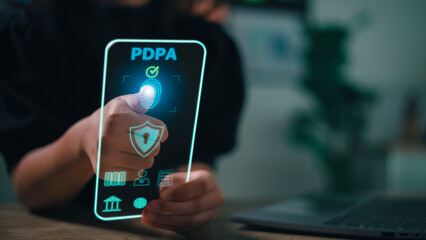 Personal Data Protection Act or PDPA concept. Women use a phone with fingerprint scanning on a futuristic virtual interface screen. Shield with lock icon protection from privacy theft.