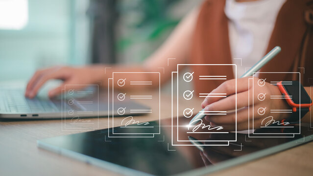 E-signing, electronic signature, document management, paperless office. Hand signing on e-document on a digital tablet, virtual notepad on virtual screen, Online contract signing with application