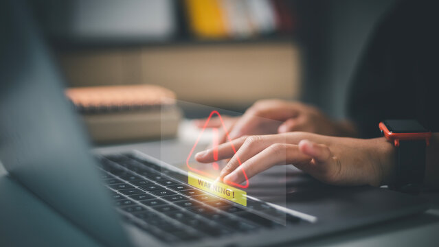 developer using computer laptop with triangle caution warning sign for notification error and maintenance concept.