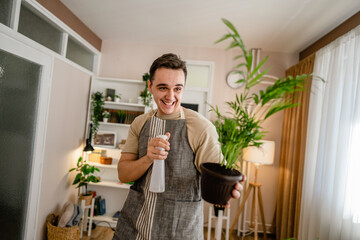 man gardener florist take care grow cultivate plants at home