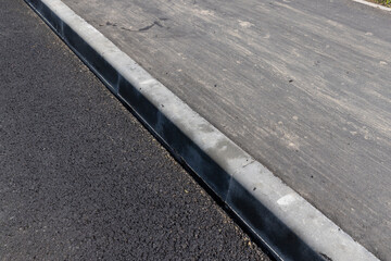 Fototapeta premium asphalting a new highway with black new asphalt